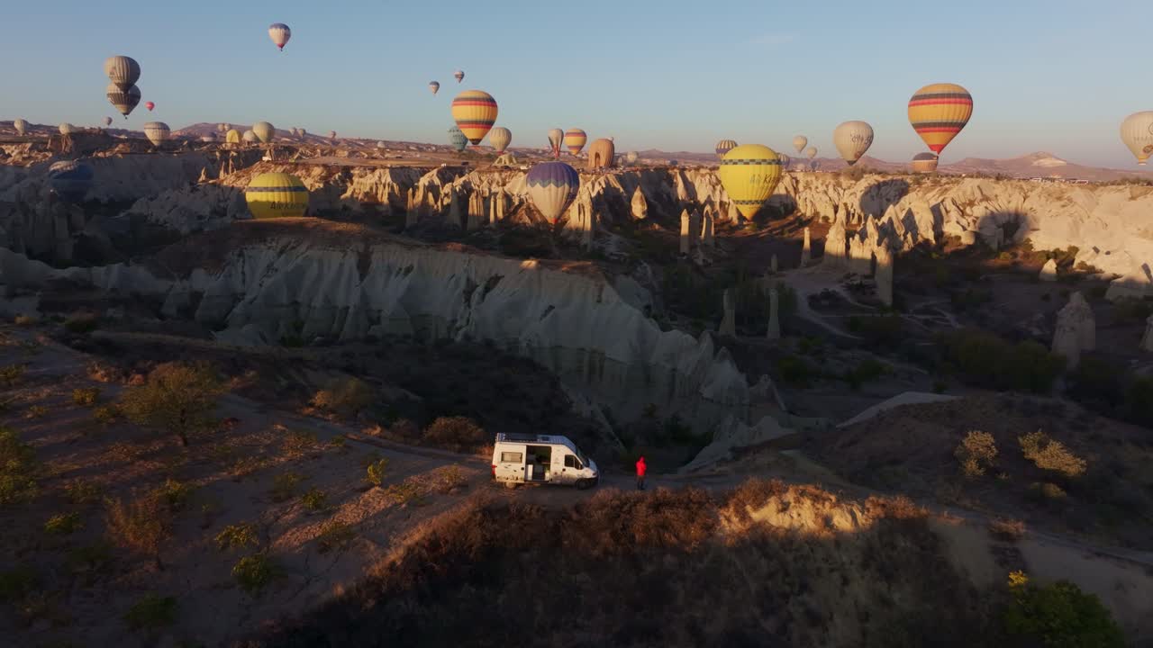 Cappadocia's Love Valley shines at sunrise with colorful balloons