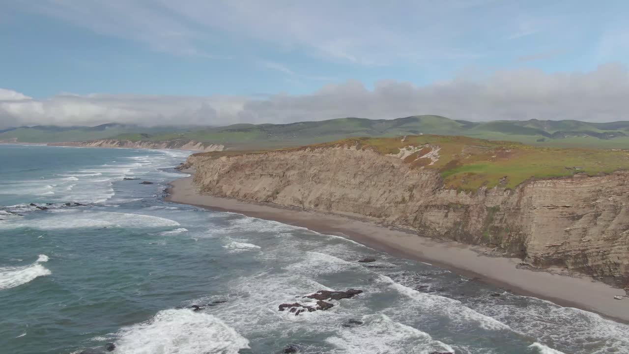 Ocean flying to California coastal cliffs 