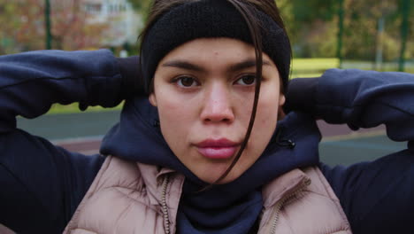 woman putting hoodie on