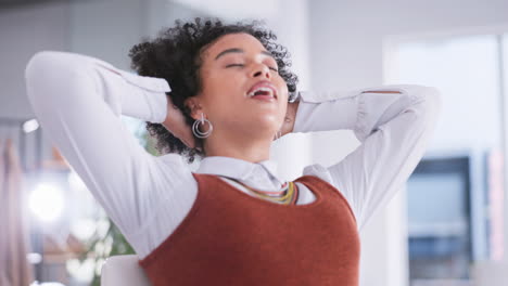 Happy-woman-stretching-at-her-desk