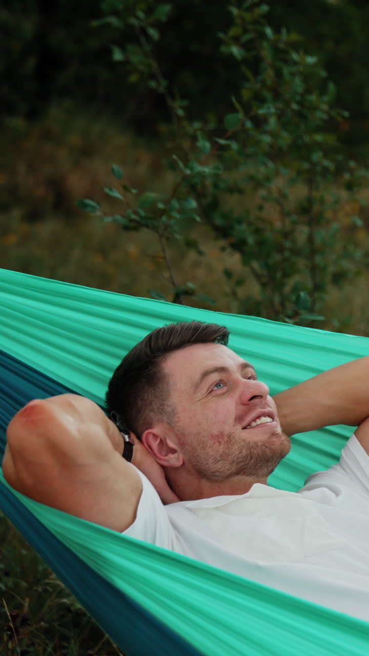 Man Relaxing in a Hammock in Nature