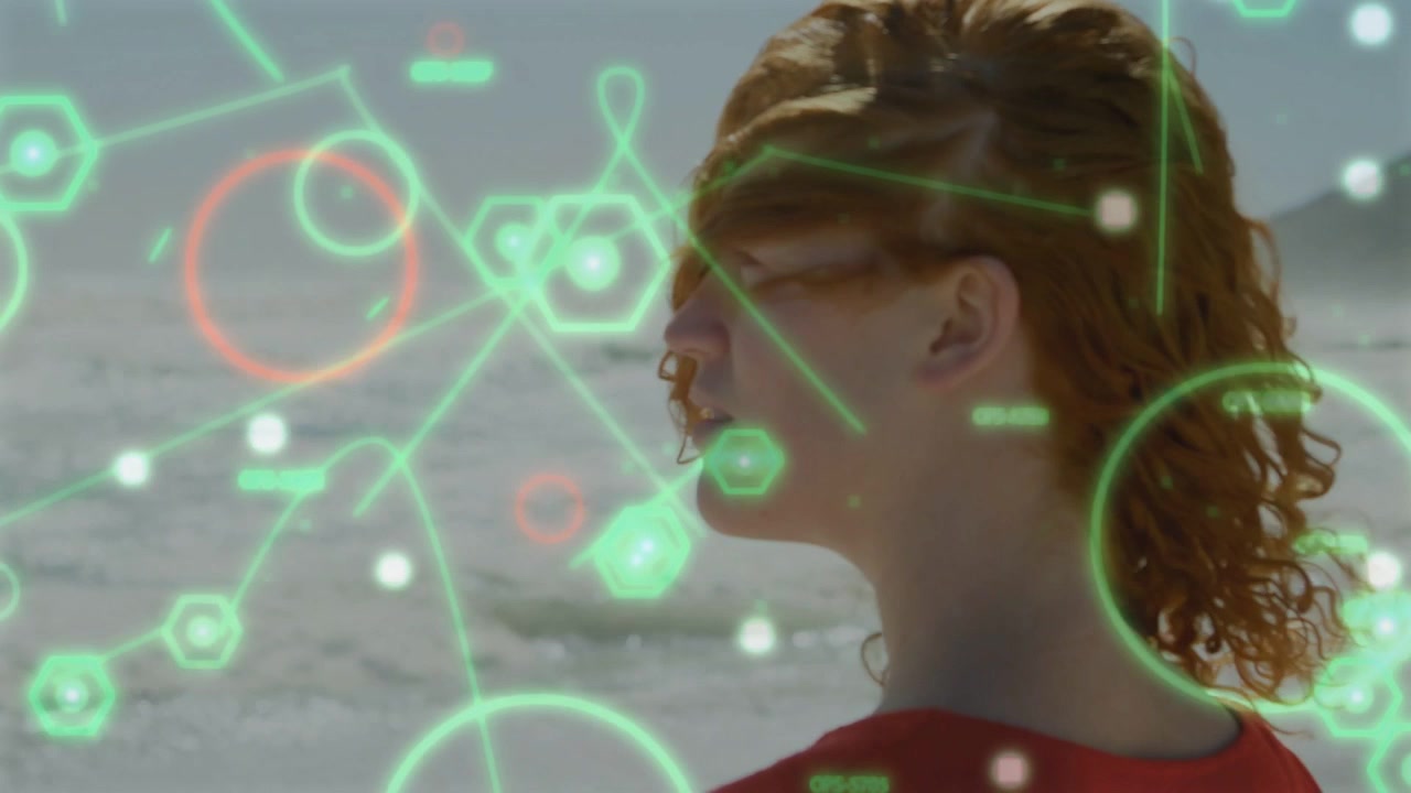 Woman standing at shoreline lifting chin and turning head while HUD graphics analyzing marine data