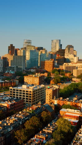 amazing panorama of boston in the rays of setting sun. drone footage above the low-rise architecture of the city.. vertical video