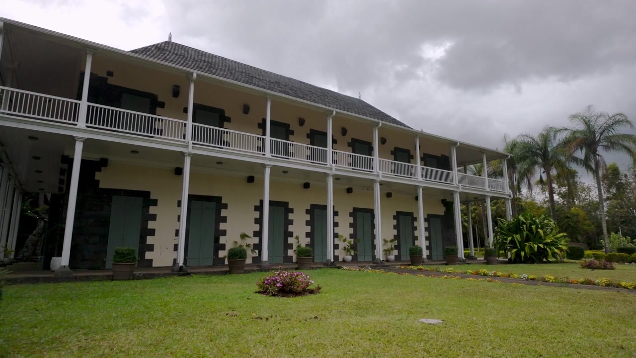 Discover the blend of colonial architecture and lush greenery at Pamplemousses Botanical Garden, Mauritius.
