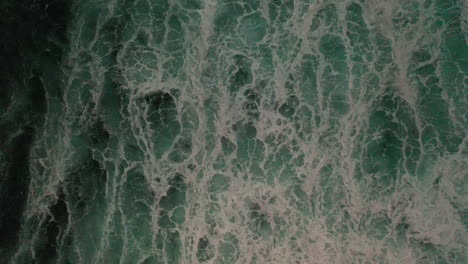 foamy turquoise blue ocean waves splashing in slow motion in oahu, hawaii - beautiful scenery - top drone shot