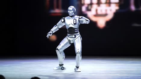 A humanoid robot showcases impressive dance moves and synchronized movements while captivating a live audience at a technology event in 2023. The interaction demonstrates advancements in robotics.