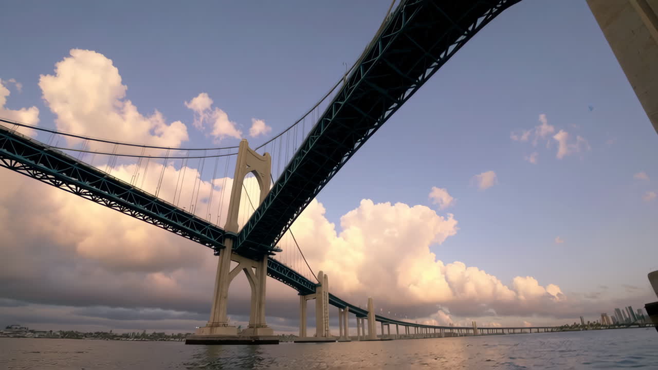 Dramatic view of a large suspension bridge from the water at dawn or dusk