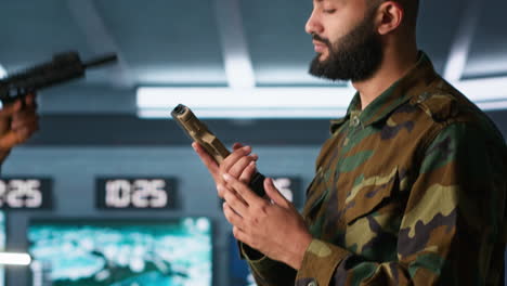 Close-up-of-army-soldier-in-command-center-packing-guns