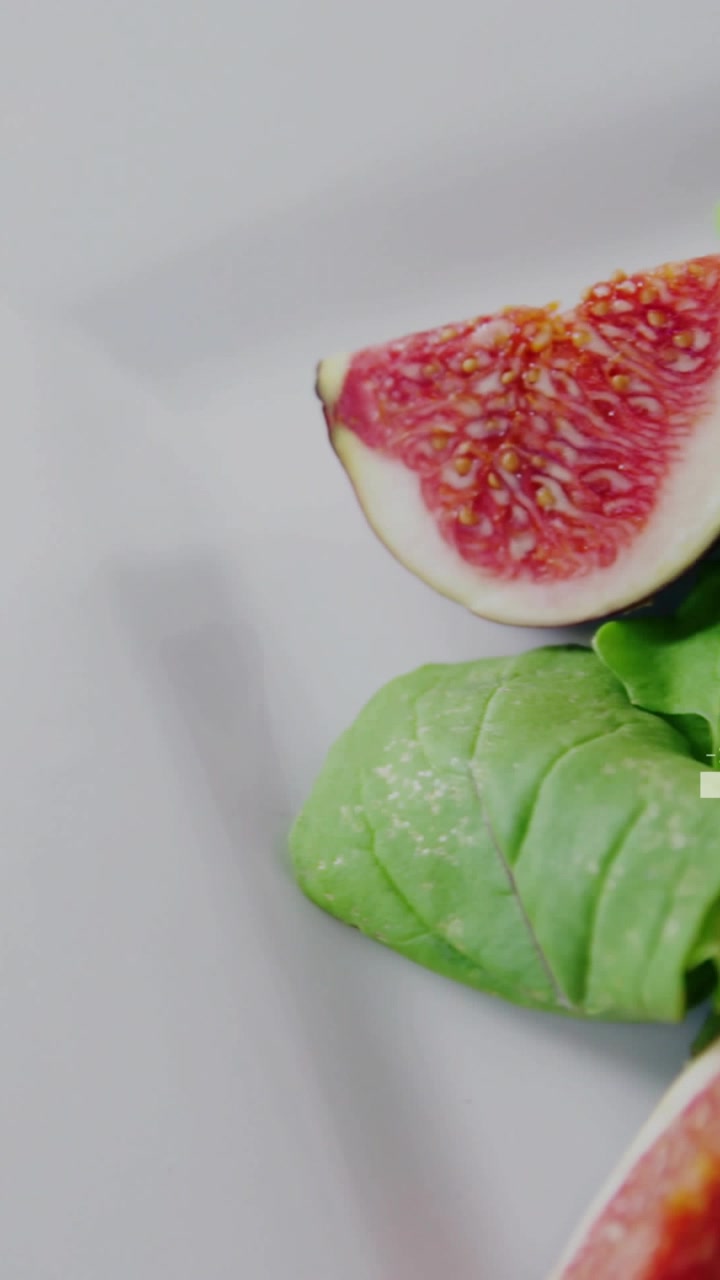 Vertical video: Camera panning closeup, zooming in while HUD tagging plate to highlight prosciutto