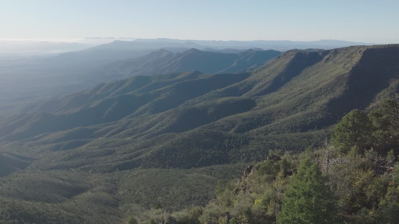 Cinematic Aerial Drone Side View of Forested Mountain Ridges and Hazy Horizon on Mingus Mountain Arizona
