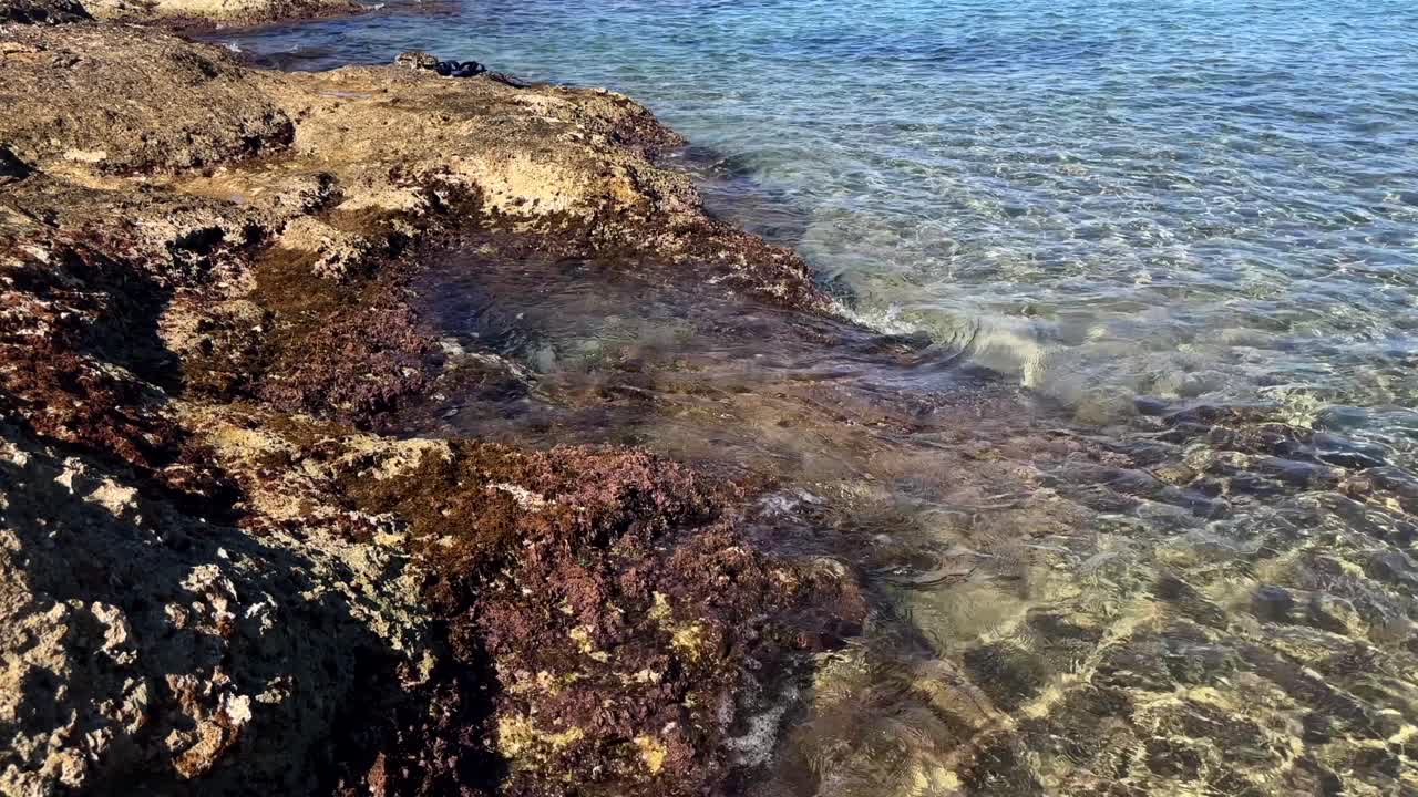 Sea rocks surrounded by clear water at a beach on Crete Island, Greece