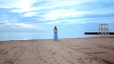 Pregnant-woman-in-long-dress-on-beach.-Pregnancy-concept
