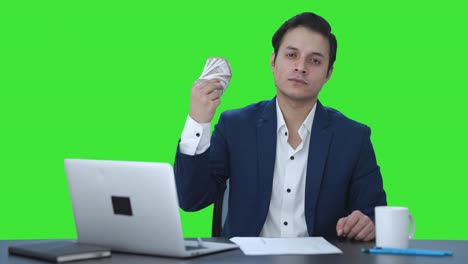 Confident-Indian-businessman-using-money-as-fan-Green-screen