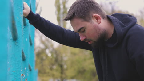 sweaty man having shortness of breath in the park in the morning