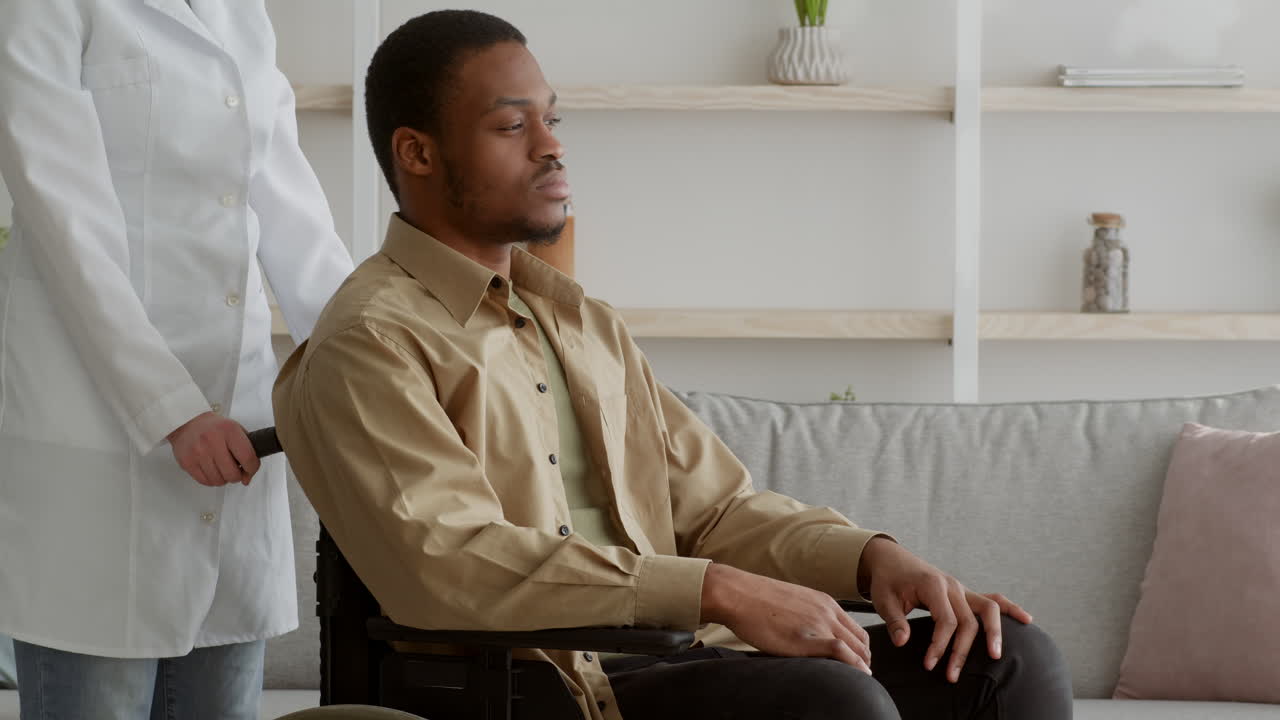 Doctor assisting a patient in a wheelchair