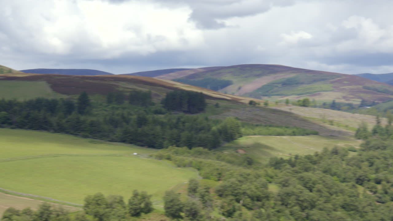Wide panning shot right to left of Glen Prosen and road near Kirriemuir on the B955