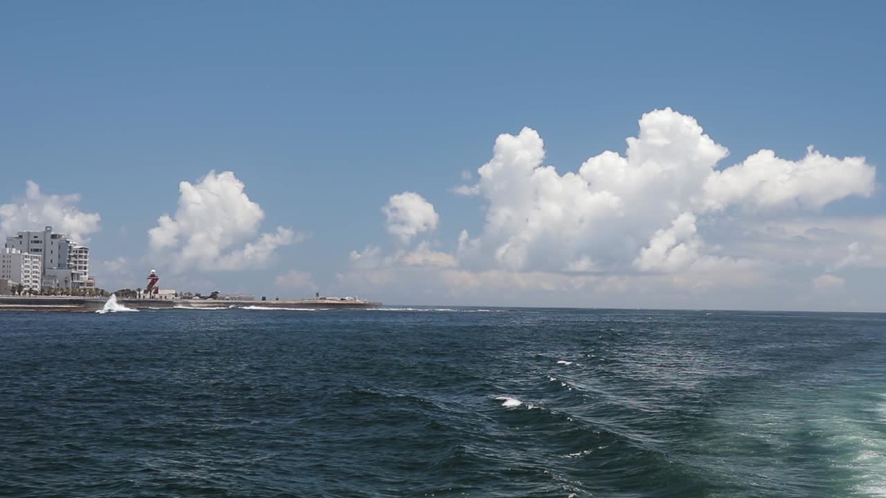 Pan shot showing Green Point Lighthouse and ocean infront of it. Filmed from a Catamaran with a Canon 200D on a Zhiyun-Tech Crane 2.