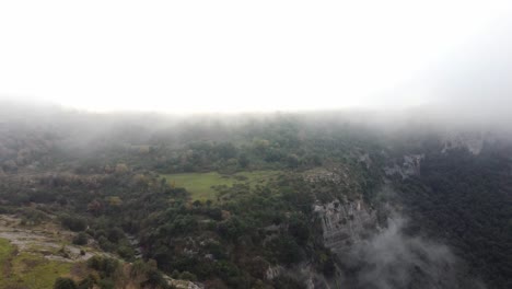 Misty-morning-over-Osona's-lush-landscape,-aerial-view