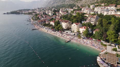 aerial drone flying above busy beach in kotor, montenegro, travel destination