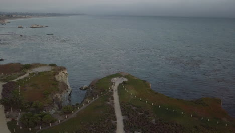 Aerial-shot-over-pathway-and-bluff-in-Pismo-Beach,-California