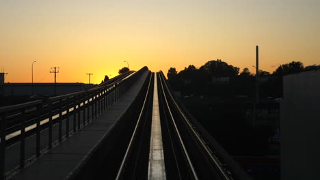sunset over city train tracks