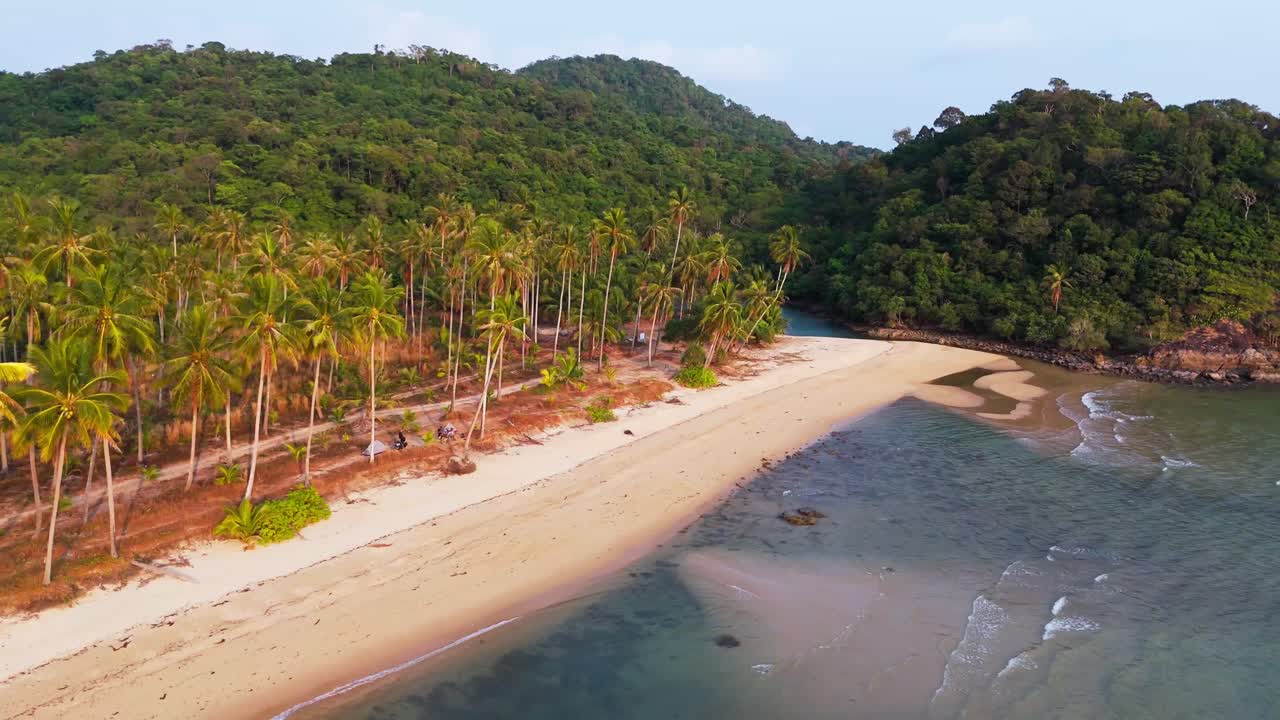 Wide zoom out view of tropical beach on Koh Chang Island in Thailand, paradise for traveling, sunny, waves on the water, copy space, background footage, youtube