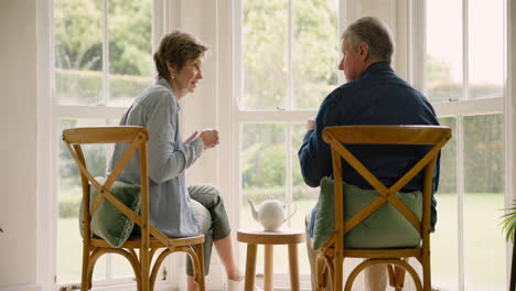 old couple in home, tea and bonding in morning