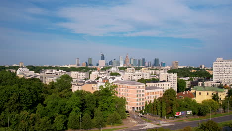 aerial panorama view showing highway with cars in suburb area of warsaw and downtown skyline in background at sunset