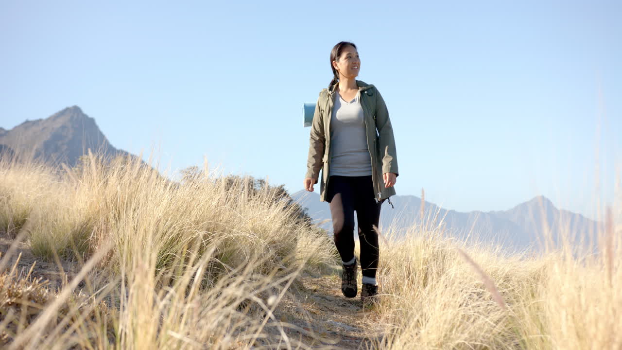 Hiking on mountain trail, woman enjoying nature and fresh air outdoors
