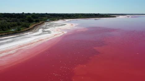 The-historical-town-of-Aigues-Mortes-in-the-Camargue,-France-during-a-sunny-summer-day-which-is-located-next-to-a-pink-salt-lake