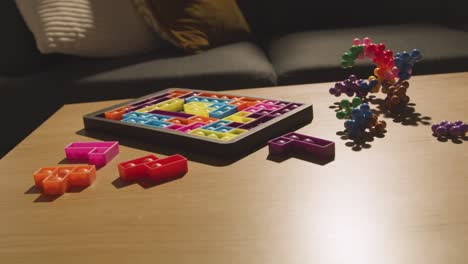 coloured interlocking shape puzzles on table at home for child diagnosed with asd 3