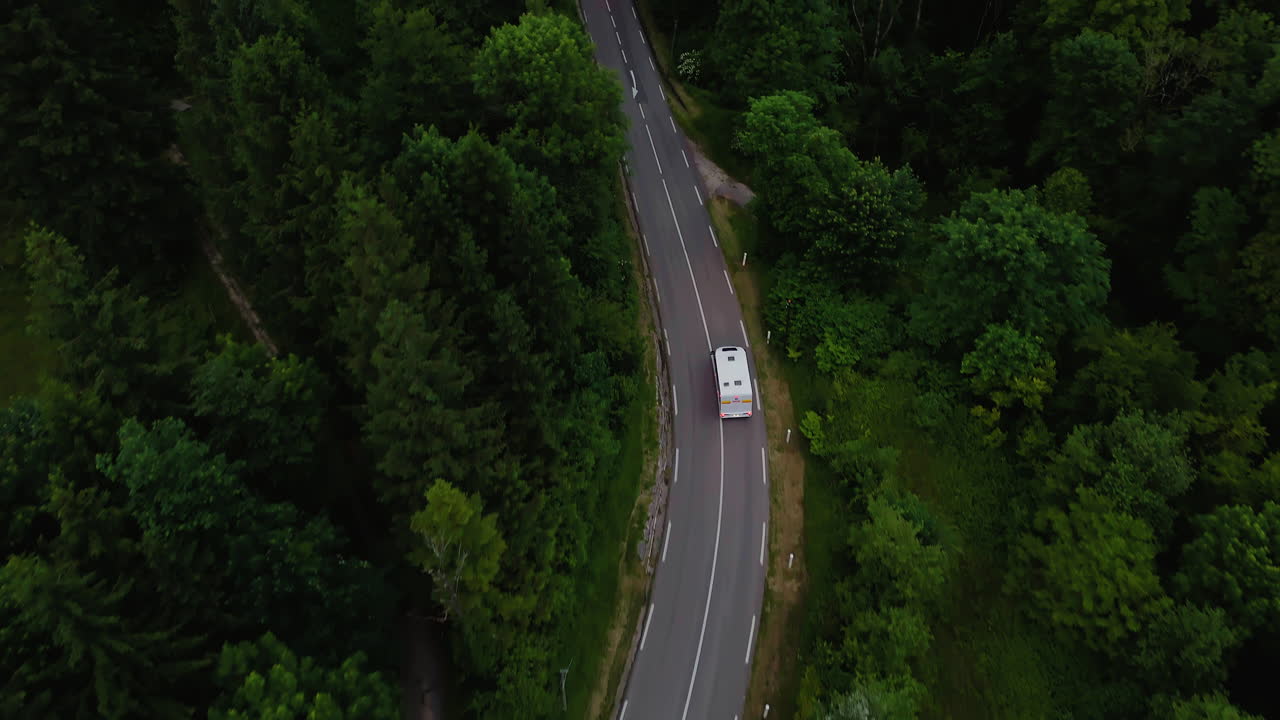 Cinematic Drone Follow of a Camper Van on a Winding Mountain Road in Alps, France