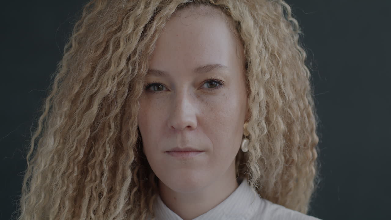 Close-up portrait of a woman with curly blonde hair