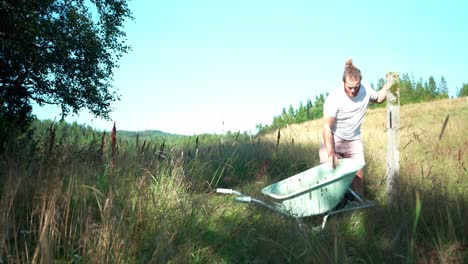 A-Man-is-Transporting-a-Concrete-Beam-for-the-Purpose-of-Constructing-a-Greenhouse---Static-Shot