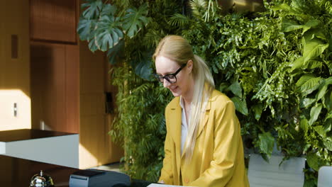 redheaded female guest carrying suitcase to the reception