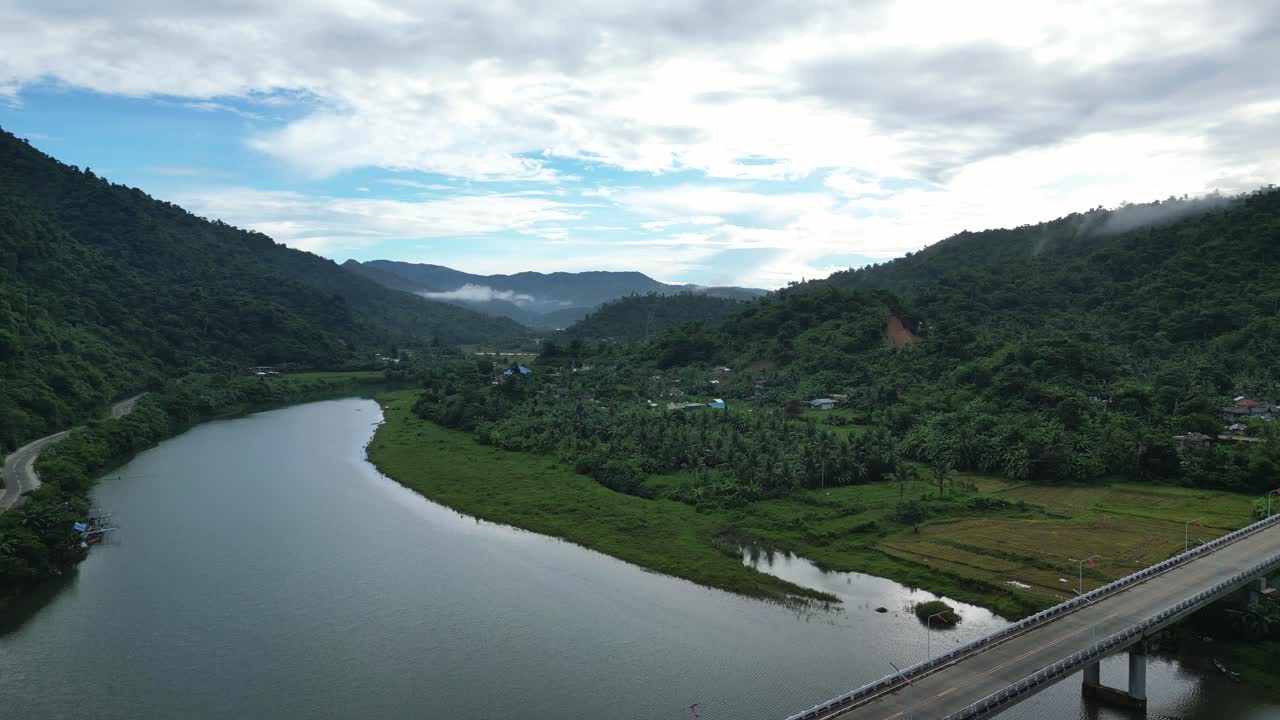평화롭고 광대한 강, 논, 무성한 정글이 있는 탁 트인 열대 계곡의 오버헤드 드론 촬영을 설정하는 영화