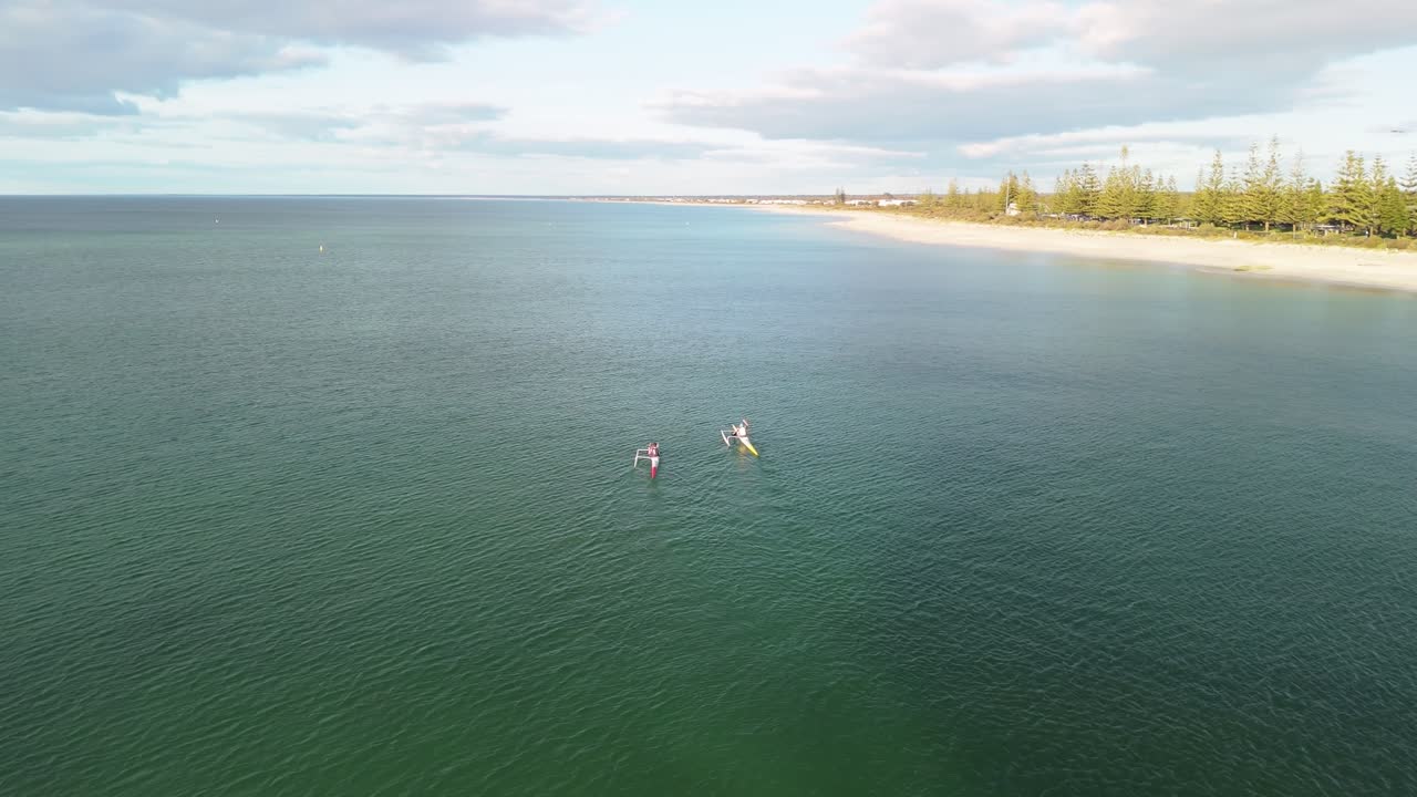 Drone flying behind couple kayaking in Busselton, Western Australia
