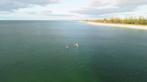 drone flying behind couple kayaking in busselton, western australia