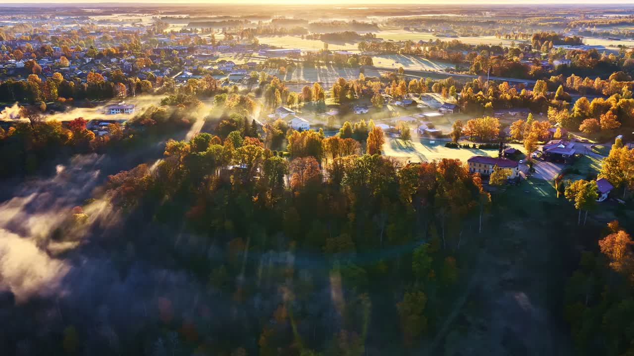 Golden autumn sunrise over Sigulda, Latvia, showcasing vibrant fall colors