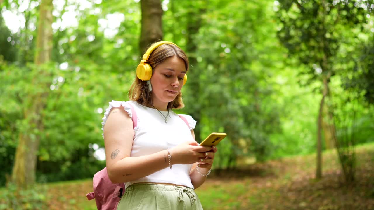 Woman with headphones in the park