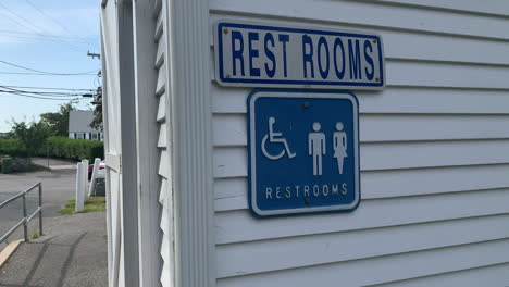 public restroom sign for male, female and handicap on a building in cape cod