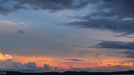 static view of huge white cruise ship passing by in evening timelapse with dark clouds visible in the sky