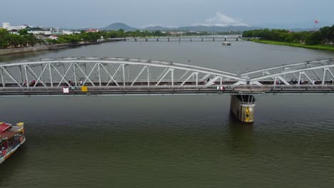 Traffic-travelling-over-Perfume-River,-city-of-Huế-Central-Vietnam