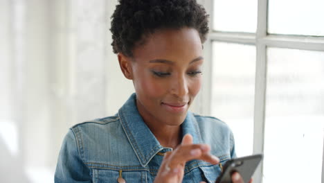 Happy-young-African-woman-using-phone