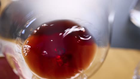 close-up of red wine swirling in glass