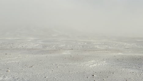 雪のスコールの間に白い雪の風景の真ん中にあるオフロード車