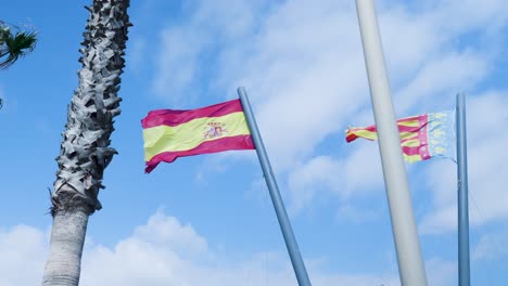 spanish and catalan flags on a sunny day