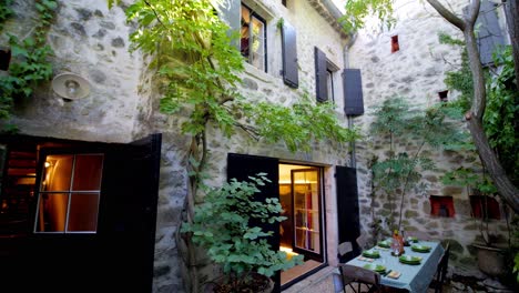 Panning-downward-shot-of-a-table-set-for-a-meal-outside-in-Lussan,-France