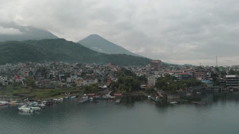 Rural-Town-Of-Santiago-At-The-Bay-Of-Lake-Atitlan-In-Guatemala---aerial-shot