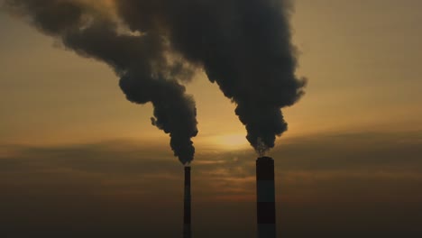 power plant emissions seen above the city during sunrise